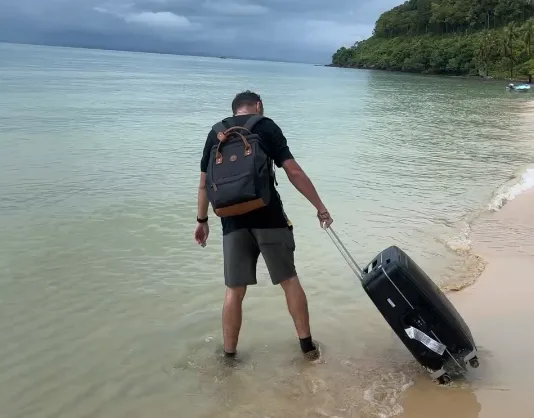 Me, abandoning the trail and running toward the sea with my water-logged suitcase